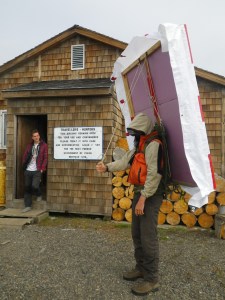 Our new home, the Hunter and Trapper’s Cabin and Joe carrying the drone landing pad.